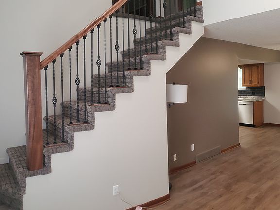 Living room with stairs going up.
