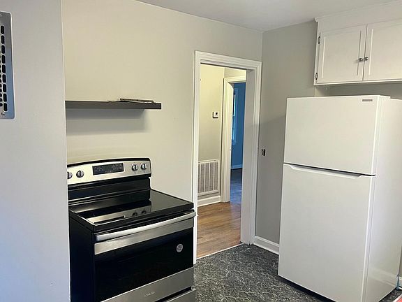 Kitchen with brand new electric stove/oven and brand new refrigerator/freezer.