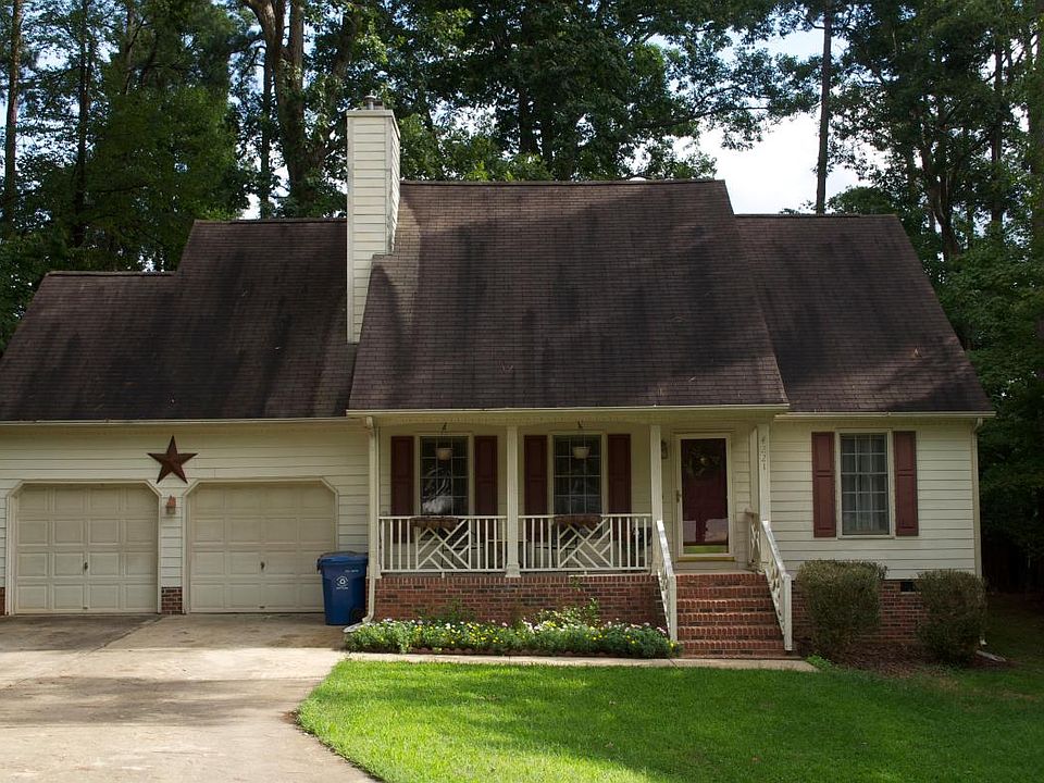 Two car garage! Large porch & wooded lot