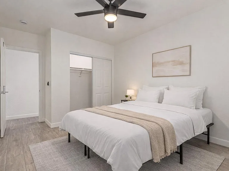 Queen Bed with Private Entrance,Bedding and rug virtually staged.