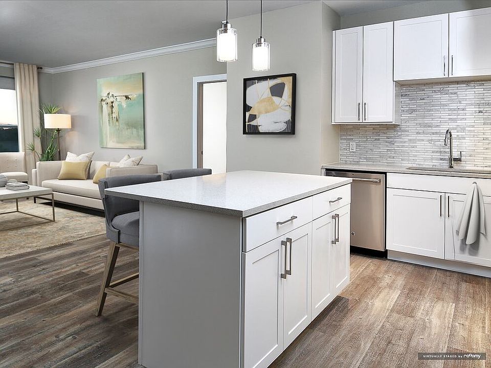 Signature Collection kitchen and living room with hard surface flooring