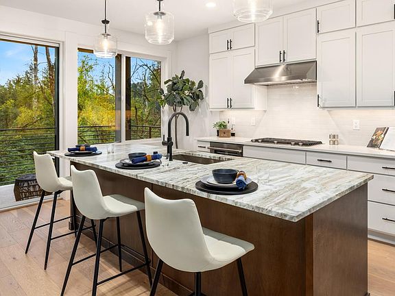 Kitchen island boasts a beautiful dolomite slab countertop with contrasting stained cabinets