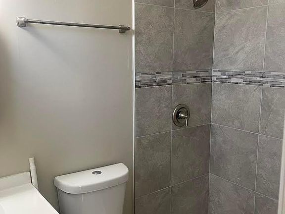 New shower in master bedroom includes new toilet, new tile and new sink