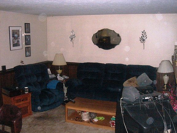 Spacious family room boasts a lovely stone gas fireplace with raised hearth.