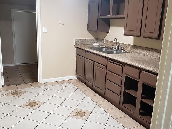 The kitchen has granite and tile floors with freshly painted cabinets. It also has a new white stove and refigerator are not pictured.
