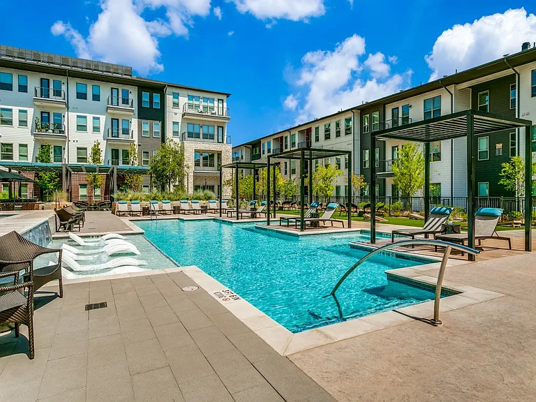 Resort-style pool with expansive sundeck and Baha shelf