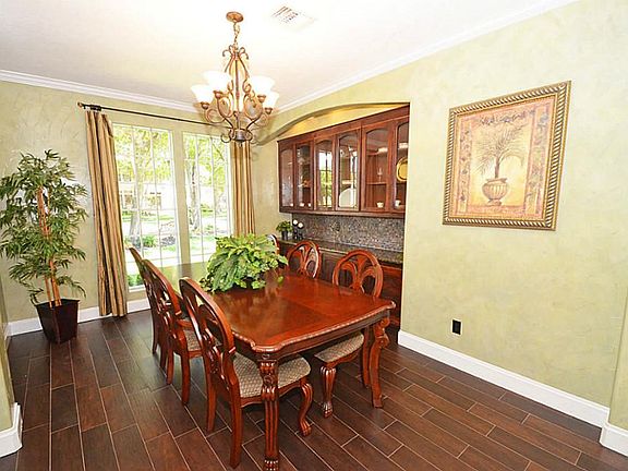 The formal dining has a built in buffet table with glass cabinet doors. The tile floors look so much