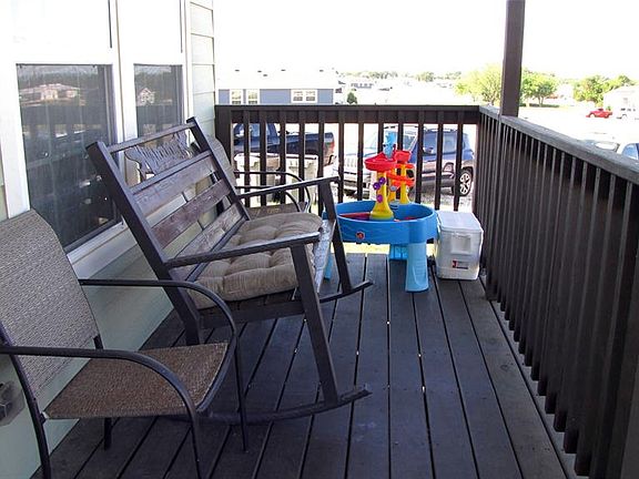 Shaded wood deck of the larger front home