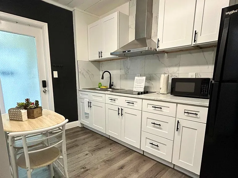 Fully equipped kitchen with coffee maker and essential amenities.