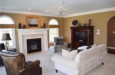 Family Room on Main has Gas Fireplace, Crown Moldings, Built-Ins & Wall of Windows