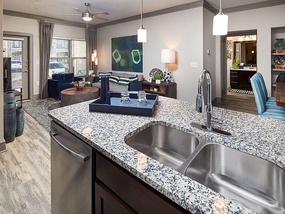 Kitchen, living, and dining areas with hard-surface flooring