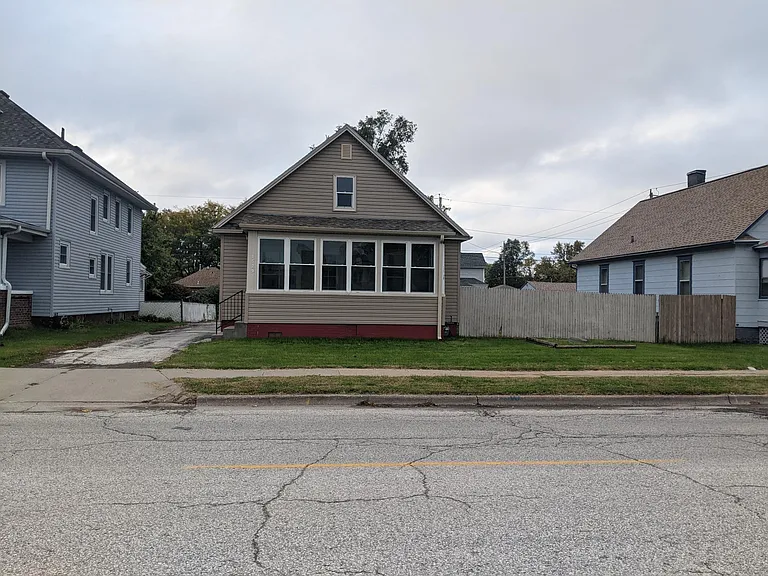 Street view. House sits on large lot.