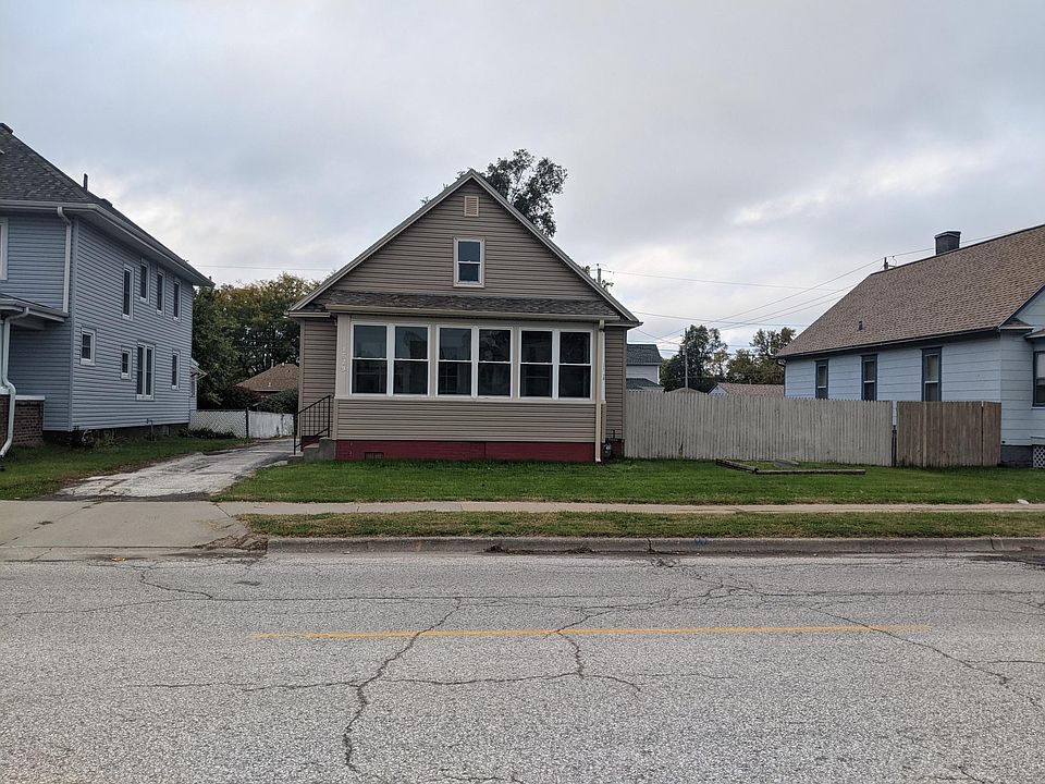 Street view. House sits on large lot.