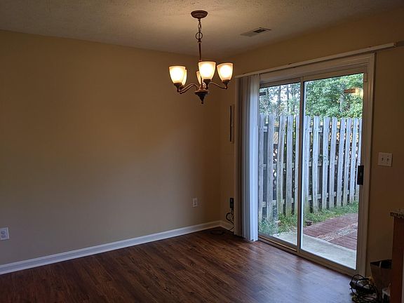 Large dining area with sliding glass doors leading to out to the backyard.