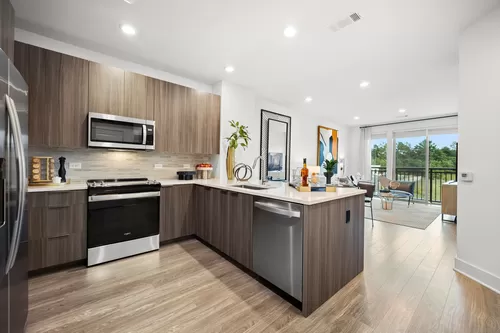Chef-inspired kitchen with premium appliances, a spacious island and premium granite countertops with open-concept floor plan - Hanover Colony Place