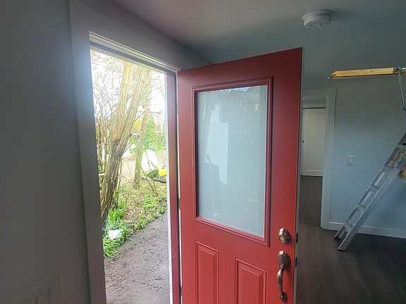 From the font door, the car parking is steps away, past garden space.