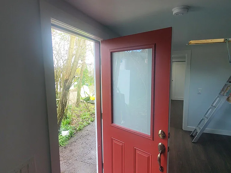 From the font door, the car parking is steps away, past garden space.