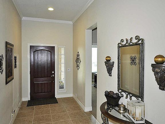  Wide foyer! Tile in heavy traffic areas & plush carpet in bedrooms & upstairs game room.  Crown molding throughout most of the home as well as double wide baseboards.
