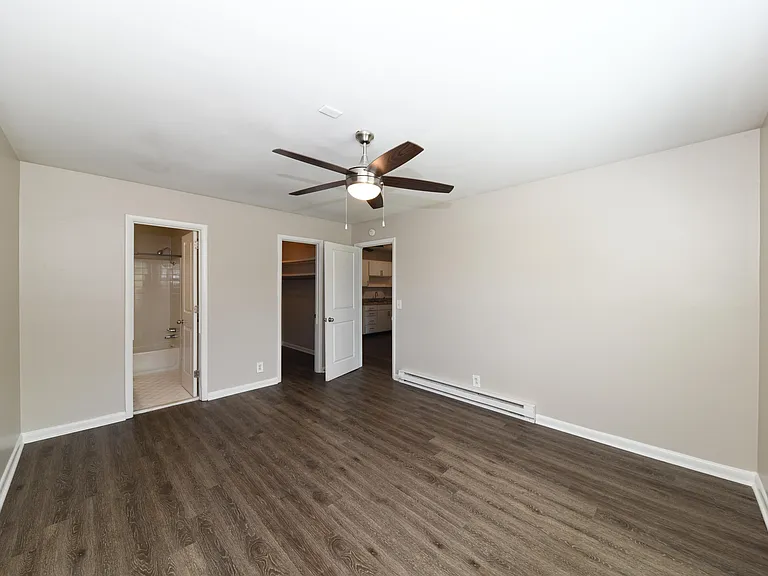 Spacious bedroom with hardwood-style flooring