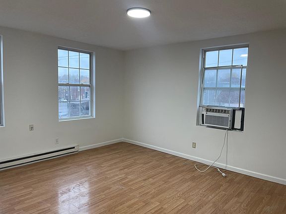 Bedroom 1 with laminate wood flooring.