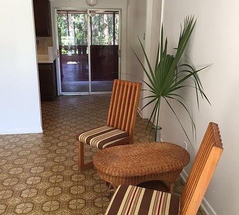 View from main room out to screeded in porch w/ceiling fan. 