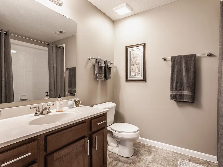 Step into a beautifully designed bathroom with a functional vanity, stylish finishes, and a bright, welcoming atmosphere.