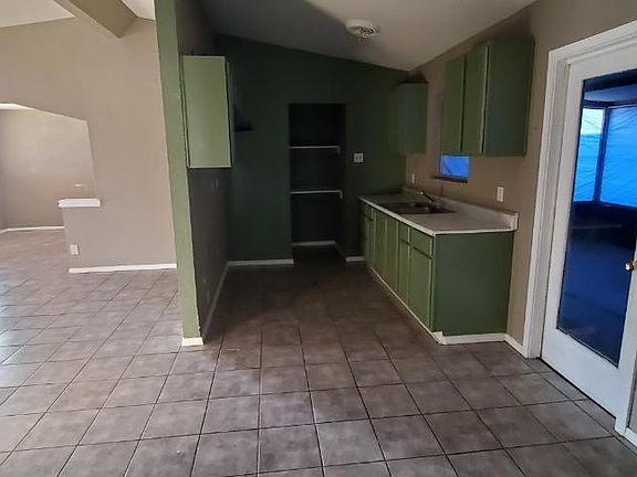 Kitchen, living room, dining area, back door.
