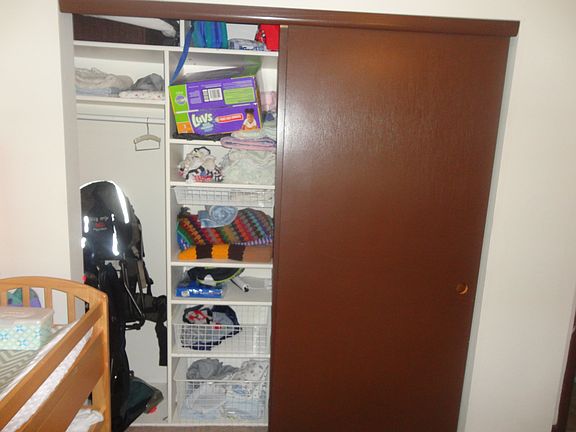 Large closet with built in shelving in bedroom 2.
