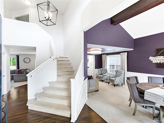 Enter to your beautiful dramatic staircase and vaulted dining/living room with designer lighting!