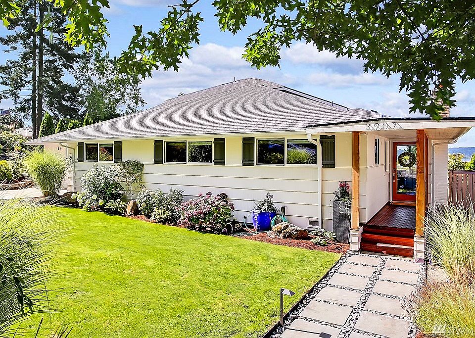 Beautifully manicured gardens greet you at this updated home with big Puget Sound views!