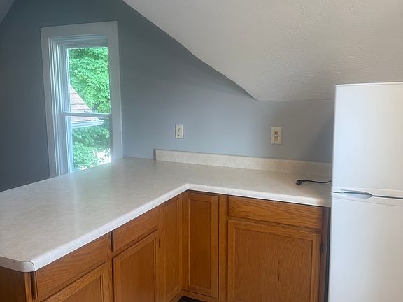 Quaint kitchen with bar area. New refrigerator.