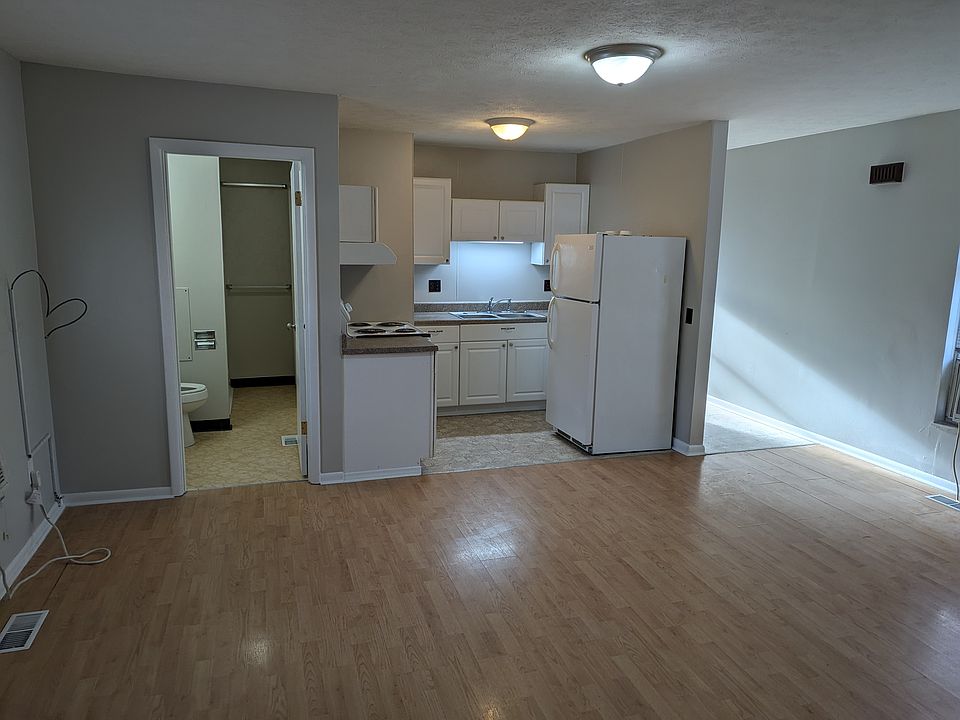 View of the living room, kitchen and bathroom.