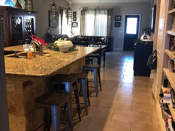 Great room with laundry room and half bath just past the bookshelf on the right