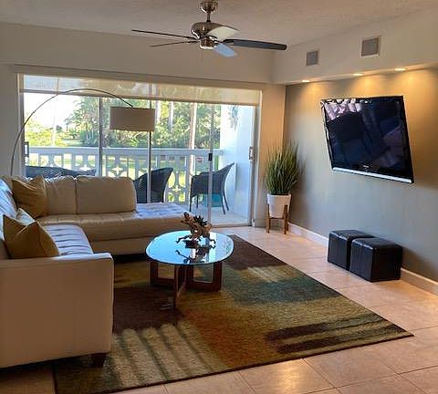 Open Living room/ Dining room with a balcony view.