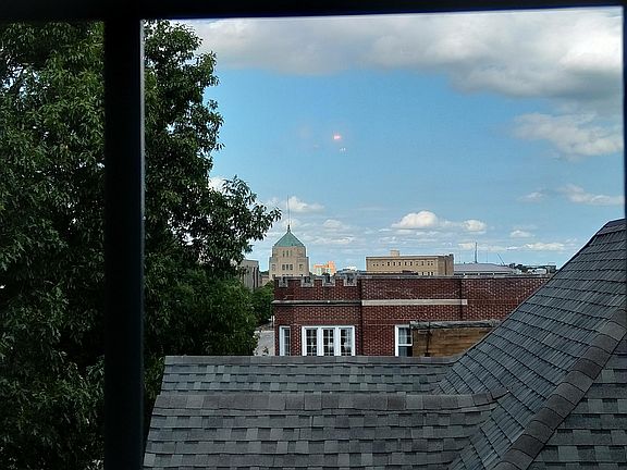 This is the view from the living room looking east. The pointy green roof is the City of Champaign's building located at University and Neil Street. This is just 2 blocks away and is the main entertainment center for night life in Champaign-Urbana.