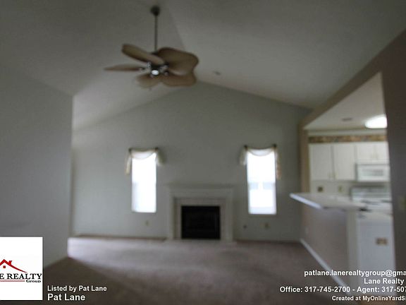 great room with faulted ceilings and gas fireplace