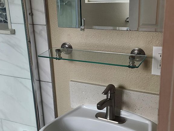 Sink with mirror and shelving