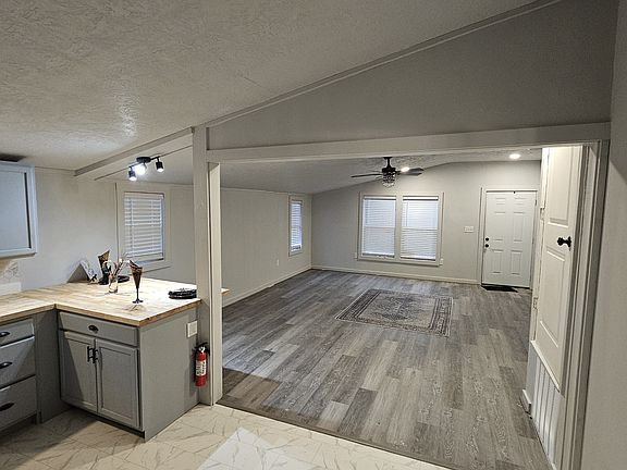 Fully renovated kitchen with new cabinetry, butcher-block countertops, stylish backsplash