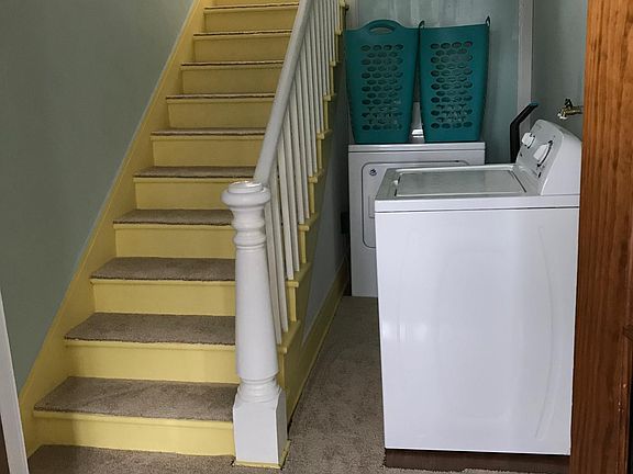 laundry area and apartment entrance going upstairs