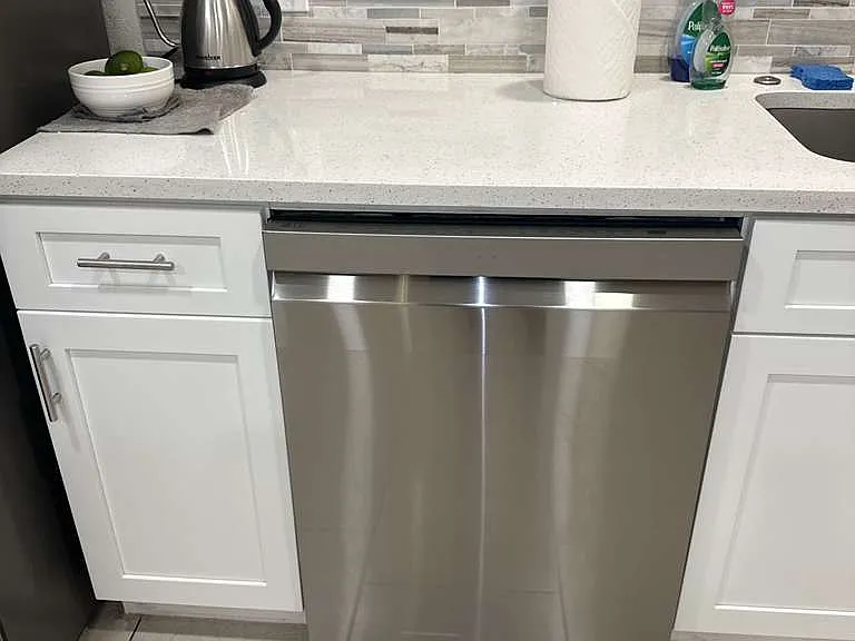 Kitchen with dishwasher and clean white cabinetry