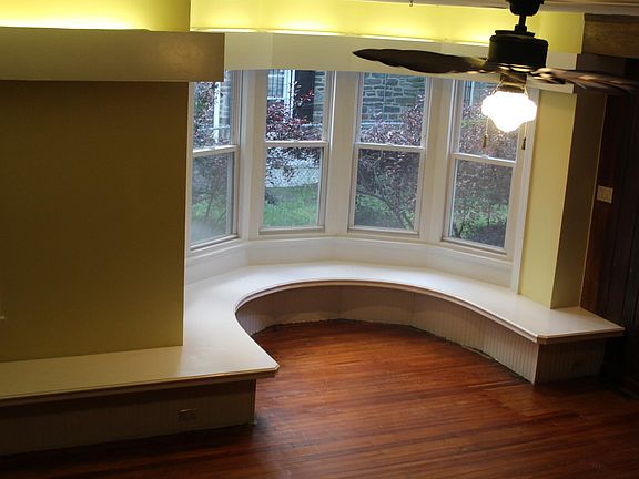 From the stairway, the big bay windows in the huge living ro