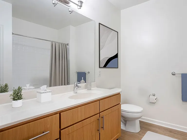 Classic Package bath with oak cabinetry, white quartz countertops, and hard surface flooring