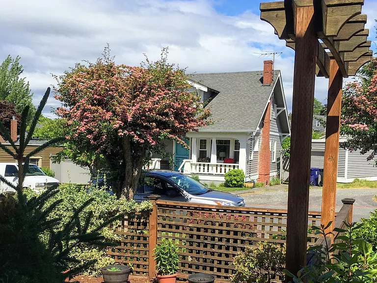 View from the shared patio/garden to neighbor's craftsman home across the street shows the typical homes in this UPS neighborhood of craftsman homes.