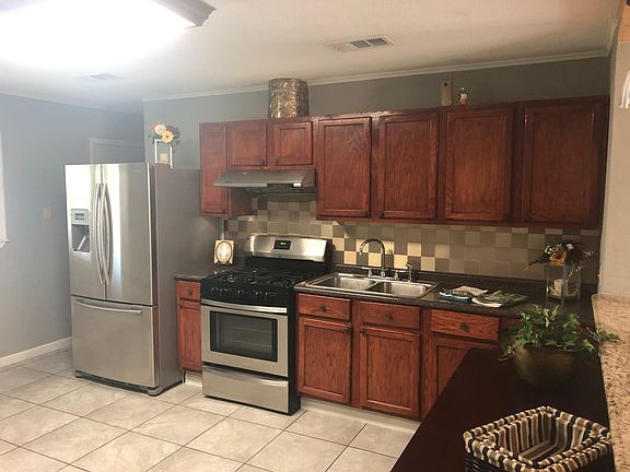 Kitchen, laundry room is past fridge