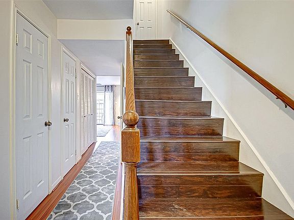As you walk in you will be greeted by pretty wood staircase and nice, bright colors.