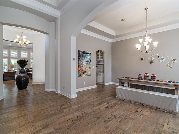Step through the double doors into a stunning entry! Gorgeous distressed Mesquite hardwood flooring extends throughout the rotunda entry into the dining, study, family room, kitchen, breakfast area and master bedroom!