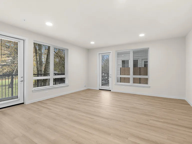 Bright and spacious apartment layout with warm wood-style floors and natural light. Bright and spacious apartment layout with warm wood-style floors and natural light.