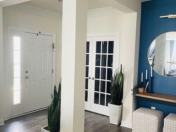 Main door and foyer showing frenchdoors to study.