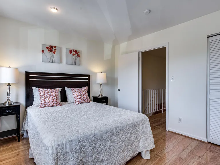Second bedroom on upper level also features hardwood floors