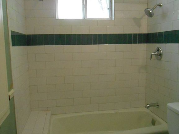 Tub surround with subway tile and glass tile accent